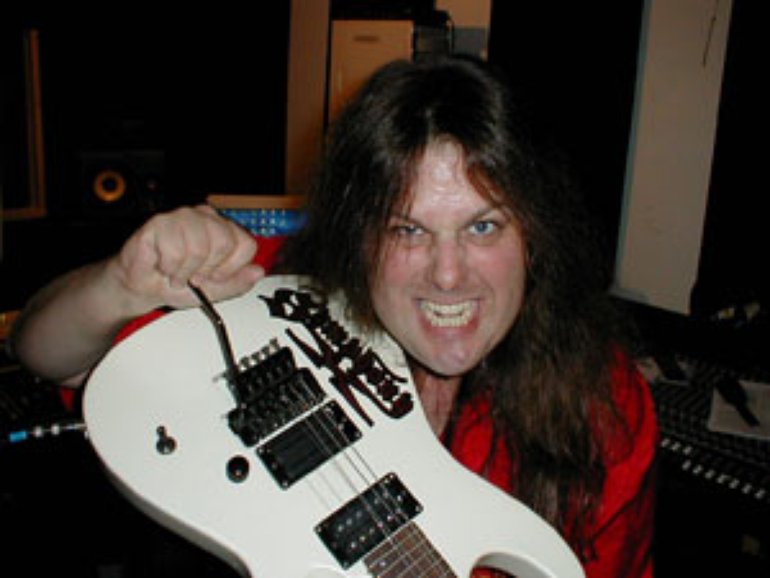 Michael Romeo holding guitar looking crazy